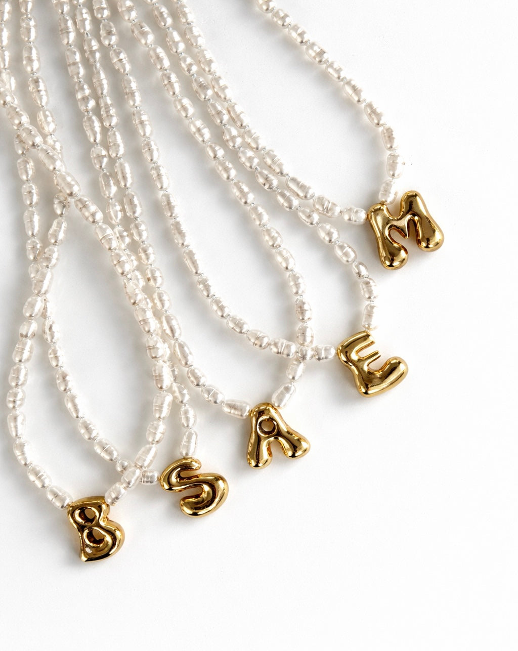 Letter pendant with a pearl necklace